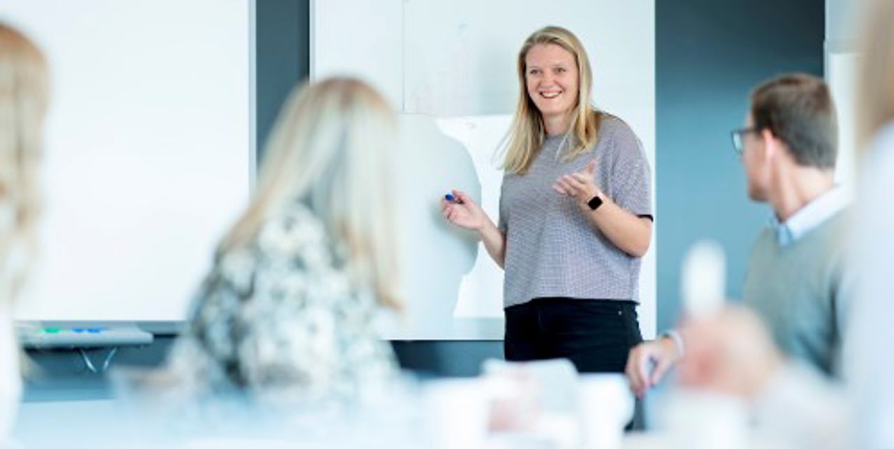 Trainee talking to group of people